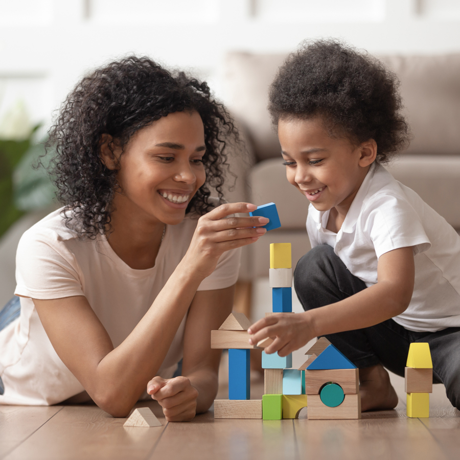 Mother playing with son and building blocks