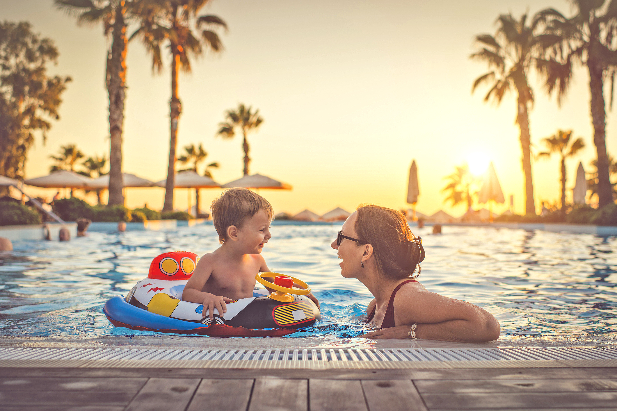 Child with mother in swimming pool, holiday resort woman and her dog in the car